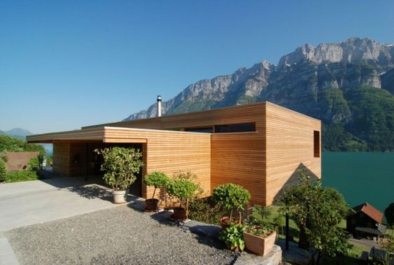 A beautifully constructed wooden house on a hillside over looking a lake