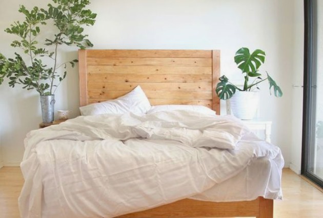 this is an image of a wooden bed that is one of the DIY ideas to make your bedroom cosy