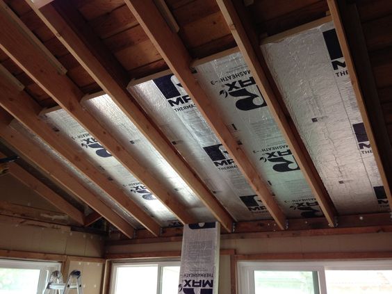 Heat insulating sheets fitted in roof of house