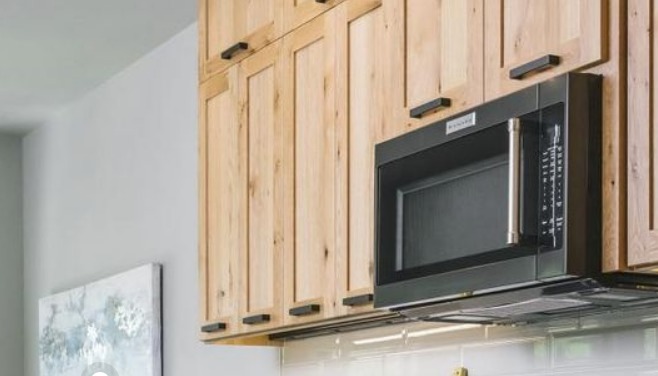 hardwood cabinets with a microwave in a kitchen