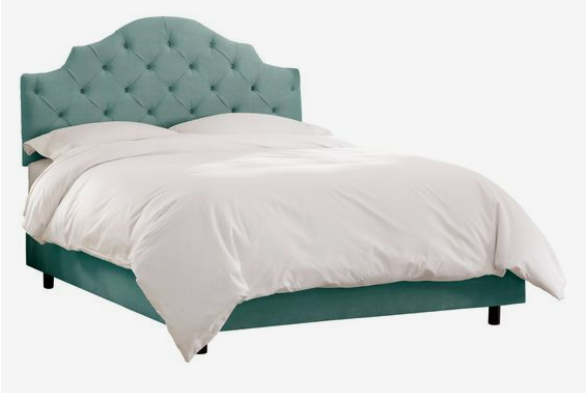 Curvaceous headboard of a bed which in one of the latest home decor trends