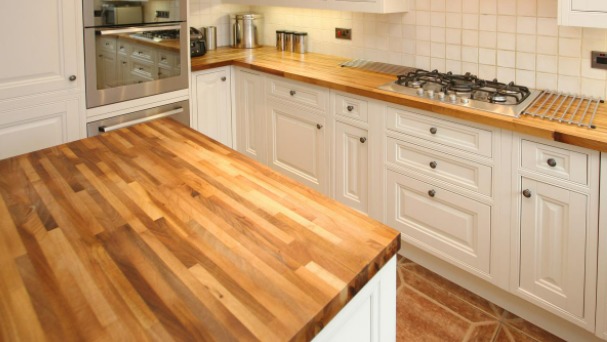a light brown butcher countertop and kitchen island