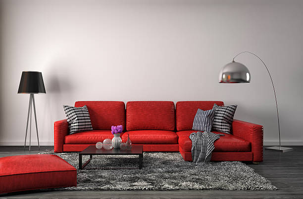 سرخ صوفوں اور سرمئی قالین اور لیمپ پر مشتمل کمرے کا انٹیریئر ڈیزائن