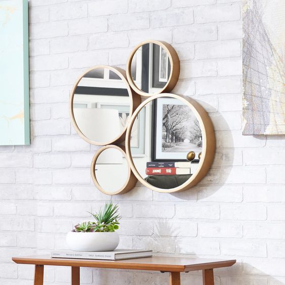 small mirrors grouped together for wall decor