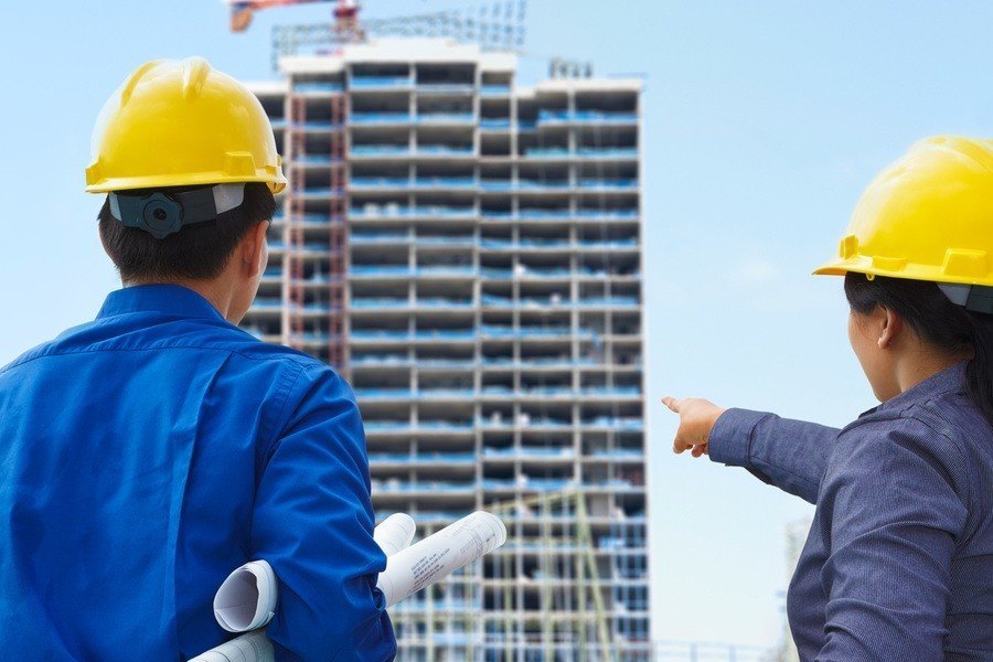builders looking at a building