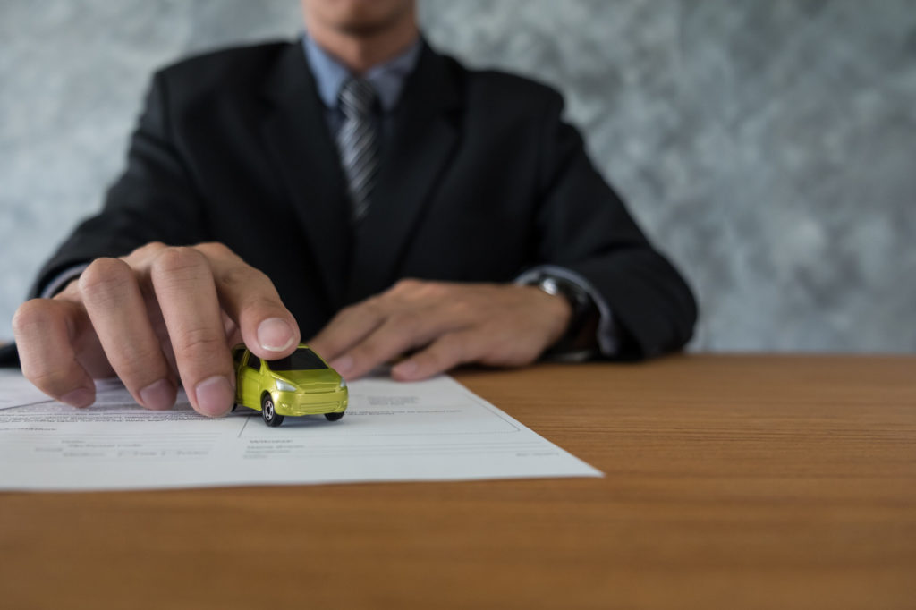 Person securing a toy car with his hand