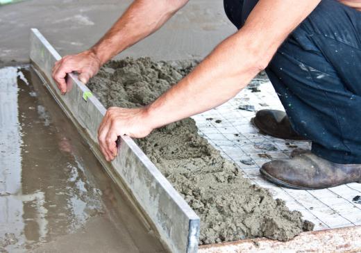 a person applying hydraulic cement onto the floor