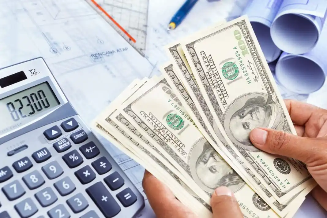 a person counting currency notes