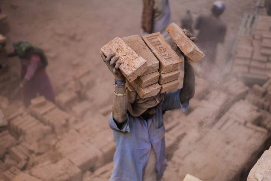a labourer carrying bricks