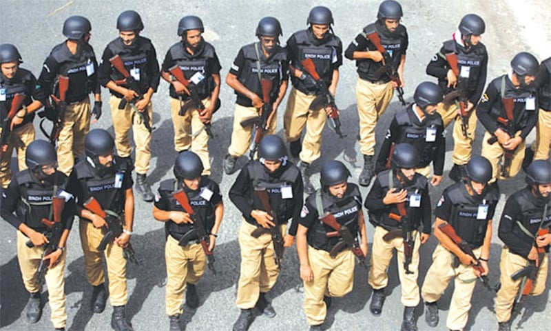 multiple armed police personnel marching