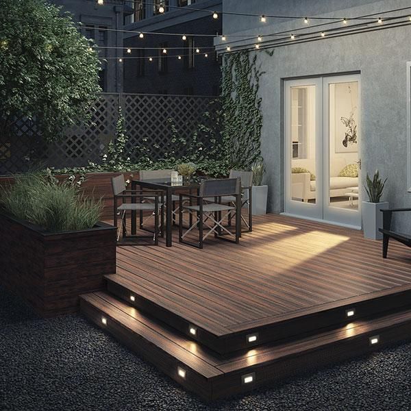 wooden deck decorated wit lights and seating arrangement