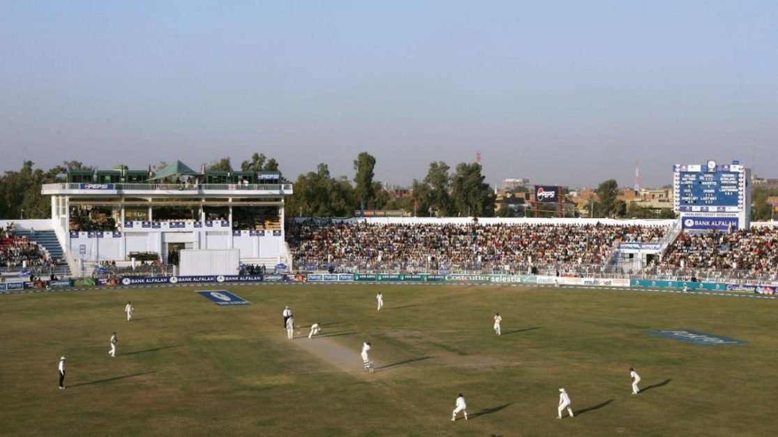 a view of Iqbal Stadium filled with spectators and team players