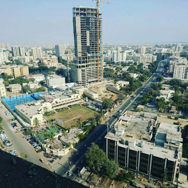 Under construction building of Hoshang Pearl surrounded by other smaller buildings in the neighborhood