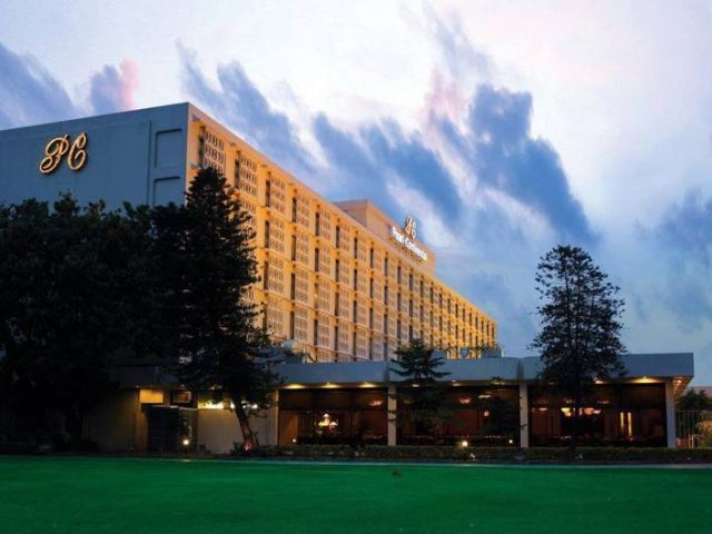 A building of PC hotel in Lahore surrounded by a lawn